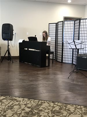 Piano student performing at Primrose Retirement Community